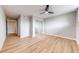 Spacious bedroom featuring ceiling fan, closet with mirrored doors and wood floors at 1100 S Orlando Ave # 301, Maitland, FL 32751