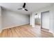 Spacious bedroom featuring ceiling fan, closet with mirrored doors and wood floors at 1100 S Orlando Ave # 301, Maitland, FL 32751