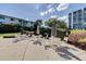 Community patio with tables, chairs, and umbrellas, and well-maintained landscaping at 1100 S Orlando Ave # 301, Maitland, FL 32751