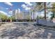 Image of condo entrance sign and covered parking area under a beautiful blue sky with light clouds at 1100 S Orlando Ave # 301, Maitland, FL 32751