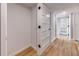 Hallway with wood floors, white doors and white trim creates a clean, modern, and inviting atmosphere at 1100 S Orlando Ave # 301, Maitland, FL 32751