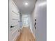 Hallway with wood floors, white doors and white trim creates a clean, modern, and inviting atmosphere at 1100 S Orlando Ave # 301, Maitland, FL 32751