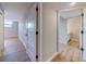 Hallway featuring hardwood floors and doors leading to a bathroom and the other rooms in the home at 1100 S Orlando Ave # 301, Maitland, FL 32751