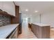View of the kitchen, with wood cabinets, stainless appliances, and center island with seating at 1100 S Orlando Ave # 301, Maitland, FL 32751