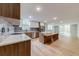 Open-concept kitchen features wood cabinets, stainless appliances, and center island at 1100 S Orlando Ave # 301, Maitland, FL 32751