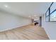 Spacious living room featuring light hardwood floors, large windows, and an open layout into the modern kitchen at 1100 S Orlando Ave # 301, Maitland, FL 32751