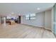 Open living room with wood floors leading to kitchen and balcony at 1100 S Orlando Ave # 301, Maitland, FL 32751