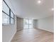 Spacious living room with sliding glass door to balcony and beautiful wood floors at 1100 S Orlando Ave # 301, Maitland, FL 32751