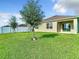 A cozy backyard space complete with outdoor seating and a modern fire pit with an expansive manicured lawn at 1133 August Sky Dr, Deltona, FL 32738