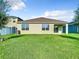 Neutral-colored exterior features a covered patio and well-maintained lawn, offering a serene outdoor living space at 1133 August Sky Dr, Deltona, FL 32738