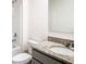 Bathroom featuring granite countertop, vanity, mirror and toilet next to white bathtub at 1133 August Sky Dr, Deltona, FL 32738