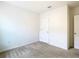 Bedroom features carpet, neutral walls, door, and electrical outlets at 1133 August Sky Dr, Deltona, FL 32738