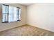 Bright bedroom features carpeted floors, sheer curtains, and a large window with plenty of natural light at 1133 August Sky Dr, Deltona, FL 32738
