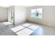 Bright bedroom with a large window and sliding glass door illuminating the neutral tile flooring at 1133 August Sky Dr, Deltona, FL 32738