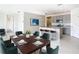 Open-concept dining area with a large table, complemented by a modern kitchen featuring granite countertops and stainless steel appliances at 1133 August Sky Dr, Deltona, FL 32738