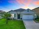 Charming single-story home featuring a well-maintained lawn and a welcoming facade with a two car garage at 1133 August Sky Dr, Deltona, FL 32738