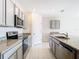 Contemporary kitchen with stainless steel appliances, granite countertops, and sleek cabinetry, offering a modern cooking space at 1133 August Sky Dr, Deltona, FL 32738