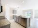 Stylish kitchen featuring granite countertops, stainless steel appliances, and ample cabinet space, centered around a functional island at 1133 August Sky Dr, Deltona, FL 32738