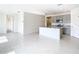 Open-concept space with tile flooring, an island, and gray cabinets, perfect for entertaining at 1133 August Sky Dr, Deltona, FL 32738