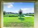 Lush pond view framed by a covered patio, blending indoor comfort with a serene natural backdrop at 1133 August Sky Dr, Deltona, FL 32738