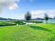 Picturesque pond view features a lush lawn and fenced yards, creating a peaceful and inviting outdoor space at 1133 August Sky Dr, Deltona, FL 32738