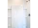 Clean, walk-in shower featuring white tile and built in shelving at 1133 August Sky Dr, Deltona, FL 32738