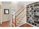 Bright foyer featuring a staircase, hardwood floors, and built in bookshelves at 1180 Killaloe Ter, Chuluota, FL 32766