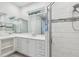 Bright bathroom with white cabinetry, double sinks, and a glass enclosed shower at 1222 Shorecrest Cir, Clermont, FL 34711