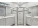 Bright bathroom with white cabinetry, double sinks, glass enclosed shower, and a separate toilet at 1222 Shorecrest Cir, Clermont, FL 34711