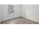 Small bedroom featuring wood floors, white walls, and a window offering natural light at 1222 Shorecrest Cir, Clermont, FL 34711