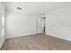 Spacious bedroom with hardwood floors, crown molding, and a view of the en-suite bathroom at 1222 Shorecrest Cir, Clermont, FL 34711