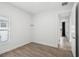 Clean bedroom with wood-look tile flooring, a bright window, and white walls at 1222 Shorecrest Cir, Clermont, FL 34711
