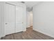 Bedroom with a closet, wood floors, and white walls, offering a simple and cozy design at 1222 Shorecrest Cir, Clermont, FL 34711