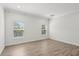 Bright bedroom with hardwood floors, crown molding, and natural light from two windows at 1222 Shorecrest Cir, Clermont, FL 34711