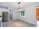 Dining room with a modern chandelier, stainless steel appliances, and tiled floors at 1222 Shorecrest Cir, Clermont, FL 34711