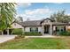 Charming single-story home with a three-car garage, and beautiful curb appeal with lush, manicured landscaping at 1222 Shorecrest Cir, Clermont, FL 34711