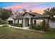 Charming single-story home featuring a stone entryway, well-manicured landscaping, and a two-car garage at 1222 Shorecrest Cir, Clermont, FL 34711