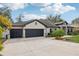 Three car garage on this lovely home with mature landscaping and beautiful curb appeal at 1222 Shorecrest Cir, Clermont, FL 34711