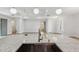 Open kitchen featuring a large island with stainless steel sink, granite countertops, and modern lighting at 1222 Shorecrest Cir, Clermont, FL 34711