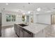 Open kitchen featuring a large island with stainless steel appliances, granite countertops, and modern lighting at 1222 Shorecrest Cir, Clermont, FL 34711