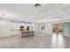 Expansive open-concept living room and kitchen area with modern lighting and tiled floors at 1222 Shorecrest Cir, Clermont, FL 34711