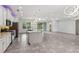 Open-concept living room adjacent to kitchen, features recessed lighting and sliding glass doors at 1222 Shorecrest Cir, Clermont, FL 34711