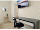This bedroom features a desk, chair, and wall-mounted TV, perfect for work and relaxation at 131 Sonja Cir # 1, Davenport, FL 33897
