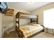 Cozy bedroom features carpet and wooden bunk beds with yellow patterned comforter at 131 Sonja Cir # 1, Davenport, FL 33897