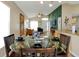 Dining room with a glass table and chairs, open to living area and modern kitchen at 131 Sonja Cir # 1, Davenport, FL 33897