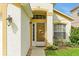 Close-up of a beautifully decorated front door with a decorative dolphin design and manicured landscaping at 131 Sonja Cir # 1, Davenport, FL 33897