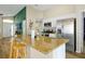 Spacious kitchen with an island, granite countertops, stainless steel appliances, and open access to other rooms at 131 Sonja Cir # 1, Davenport, FL 33897