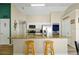 Bright kitchen featuring a large island with bar seating, granite countertops, and stainless steel appliances at 131 Sonja Cir # 1, Davenport, FL 33897