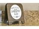 A charming coffee bar sign sits atop the granite countertops at 131 Sonja Cir # 1, Davenport, FL 33897