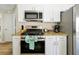 Updated kitchen featuring granite countertops, stainless appliances, and white cabinets at 131 Sonja Cir # 1, Davenport, FL 33897